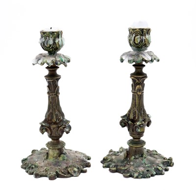 Lot 14 - A near pair of bronze table candlesticks, in...