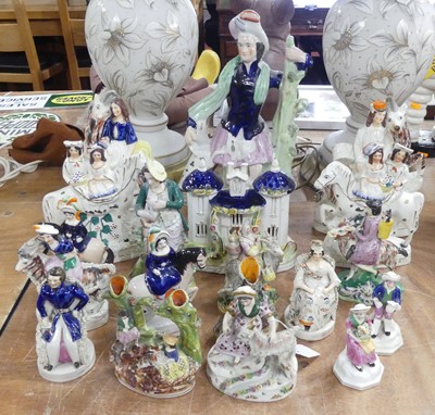 Lot 38 - A collection of Staffordshire figures, to...