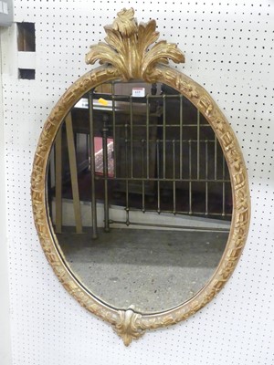 Lot 615 - A giltwood and gesso framed oval wall mirror,...