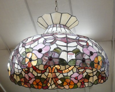 Lot 672 - A Tiffany style leaded coloured glass domed...