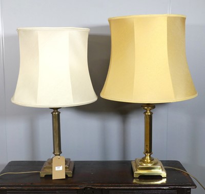 Lot 640 - A pair of lacquered brass pedestal table lamps,...
