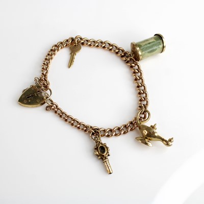 Lot 276 - A 9ct gold curblink bracelet, with heart...