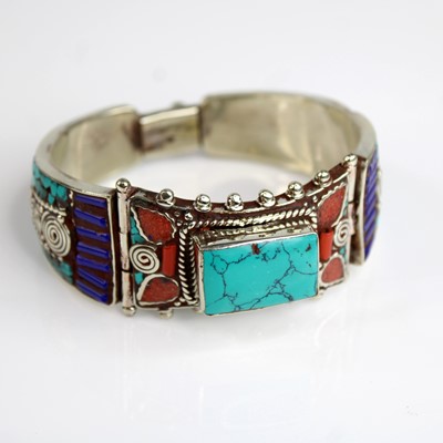 Lot 293 - A Tibetan white metal and hardstone set cuff...
