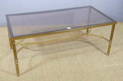 Lot 681 - A gilt brass and smoky glass topped...