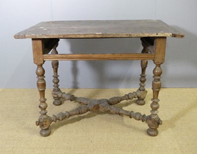 Lot 750 - An antique joined walnut plank topped side...
