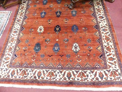 Lot 764 - A Persian woollen red ground Sarouk rug, 252 x...