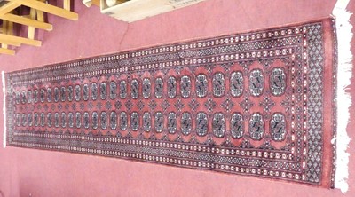 Lot 771 - A Persian woollen red ground Bokhara hall...