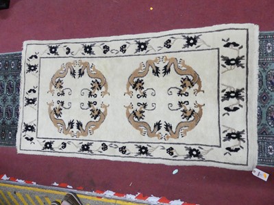 Lot 776 - An Oriental cream ground dragon decorated rug