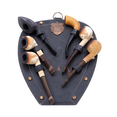 Lot 35 - A black leather horseshoe-shaped hanging pipe...