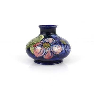 Lot 247 - A Moorcroft Clematis pattern pottery squat...