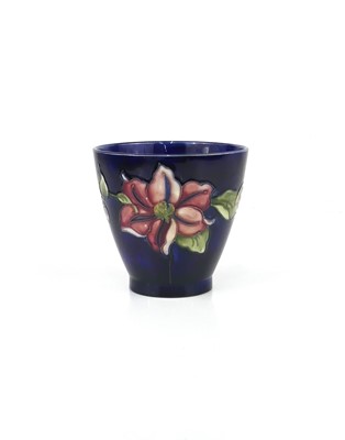 Lot 261 - A Moorcroft Clematis pattern pottery footed...