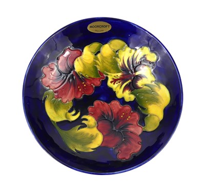 Lot 267 - A Moorcroft Hibiscus pattern pottery footed...