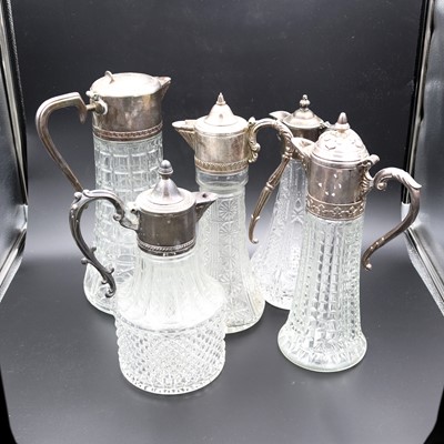 Lot 51 - A group of five moulded glass claret jugs,...