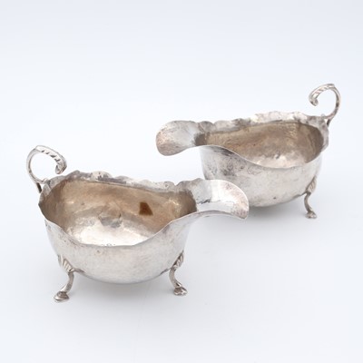 Lot 79 - A near-pair of Edwardian silver sauceboats,...