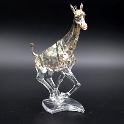 Lot 95 - A Swarovski crystal figure 'Running Giraffe',...