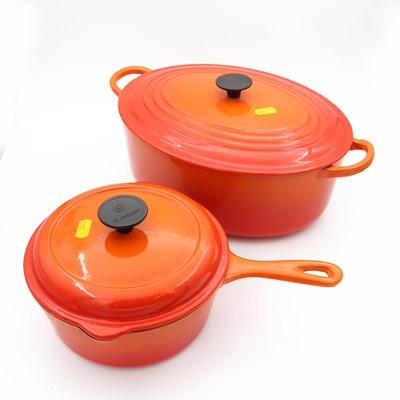 Lot 38 - A Le Creuset orange enamel glazed casserole...
