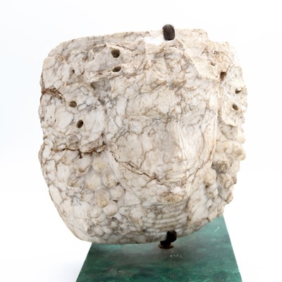Lot 19 - A marble sculpture carved as a face amongst...