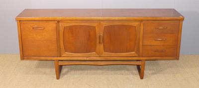 Lot 633 - A 1960s British teak long sideboard, having...