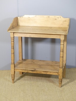 Lot 635 - A rustic pine three-quarter gallery backed two-...