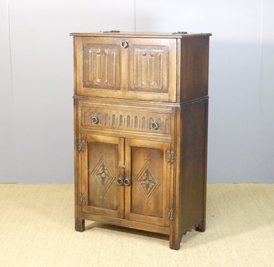 Lot 639 - A contemporary moulded oak linenfold drinks...