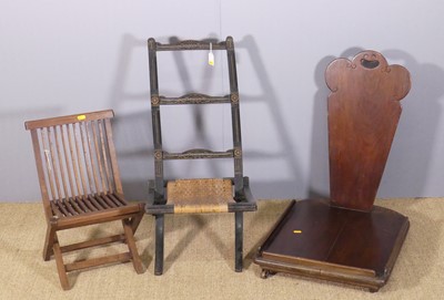 Lot 647 - A child's ebonised and rush seated X-frame...