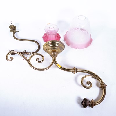 Lot 37 - An early 20th century brass scroll wall light,...