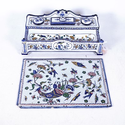 Lot 61 - A French polychrome decorated faience encrier,...