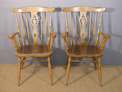 Lot 676 - A pair of contemporary beech splatback elbow...