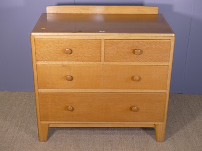 Lot 692 - A 1960s blond oak ledge back chest by Enham,...