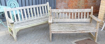 Lot 723 - A teak slatted three-seater garden bench,...