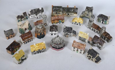 Lot 139 - A collection of pottery model cottages, to...