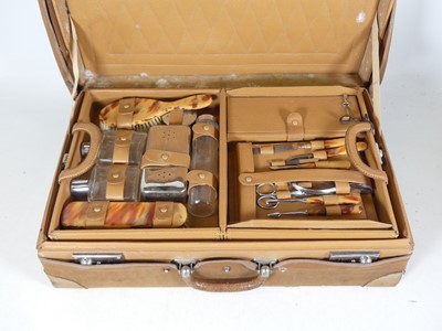 Lot 234 - An Art Deco vanity case, the simulated leather...