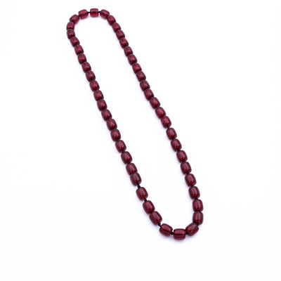 Lot 323 - A beaded faux cherry amber necklace each bead...