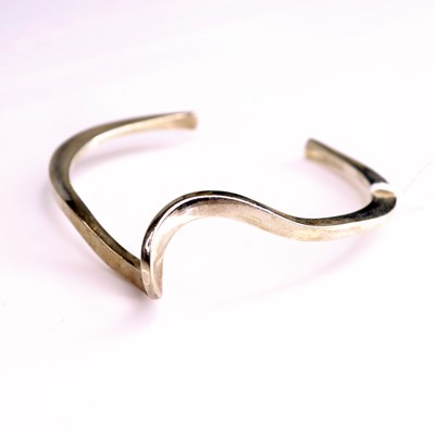 Lot 325 - A contemporary silver bangle, sponsor PGK, dia....