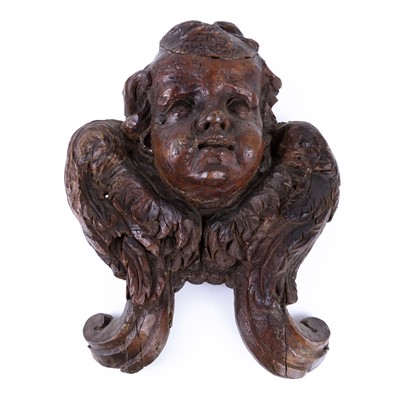 Lot 153 - An antique carved walnut cherub head, with...