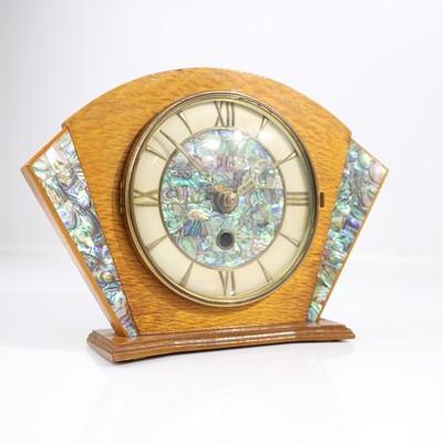 Lot 413 - An Art Deco oak mantel clock, decorated with...