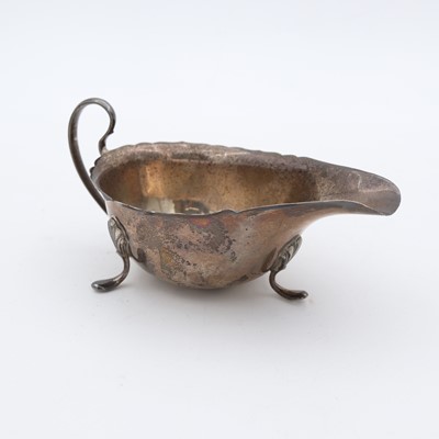 Lot 248 - A George V silver sauceboat, having wavy rim...