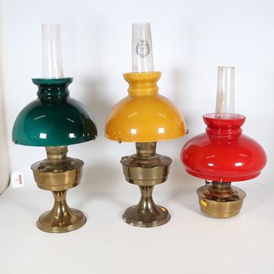 Lot 5 - A group of three 20th century brass oil lamps,...