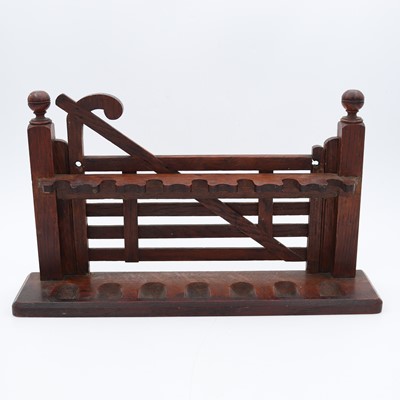 Lot 14 - An early 20th century oak novelty pipe rack,...