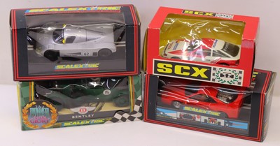 Lot 235 - 4 various Scalextric and SCX slot racing cars,...