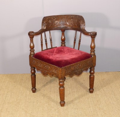 Lot 676 - An early 20th century floral relief carved oak...