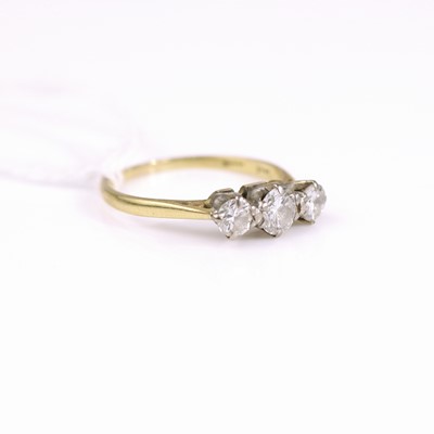 Lot 310 - An 18ct gold diamond three stone ring as claw...