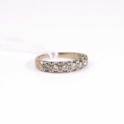 Lot 312 - An 18ct white gold diamond half eternity ring,...