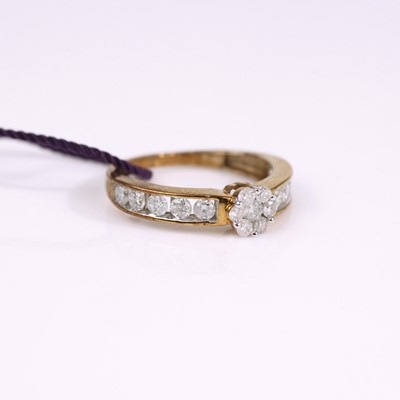 Lot 319 - A modern 9ct gold diamond dress ring arranged...