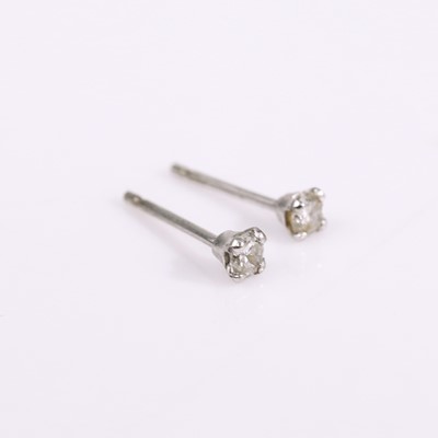 Lot 322 - A pair of white metal diamond set ear studs...