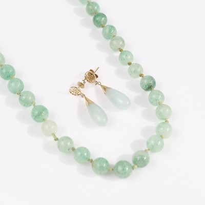 Lot 330 - A beaded jadeite necklace strung knotted, each...