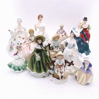 Lot 102 - A collection of porcelain figures, to include...