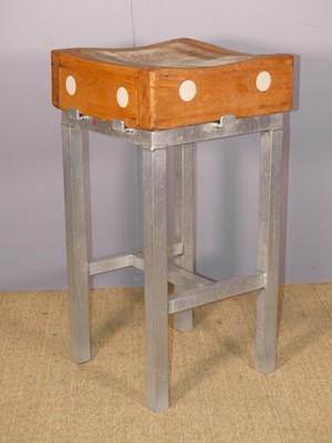Lot 696 - A compact square butcher's block, raised on...