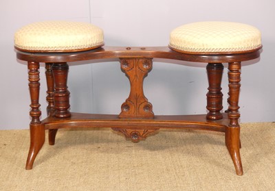 Lot 701 - An Edwardian walnut twin music stool, having...