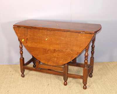 Lot 710 - An antique joined oak drop leaf gateleg table,...